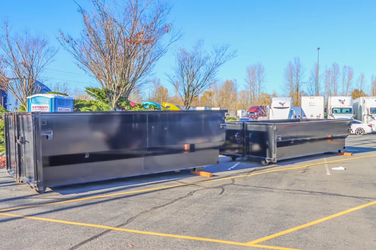 Professional dumpster rental service with roll-off container on residential driveway in Blairstown